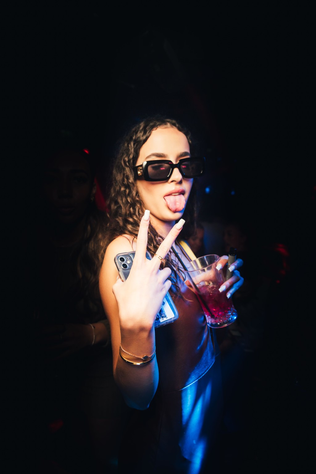 A girl posing for the camera at Tape London, one of the best clubs for couples in London.